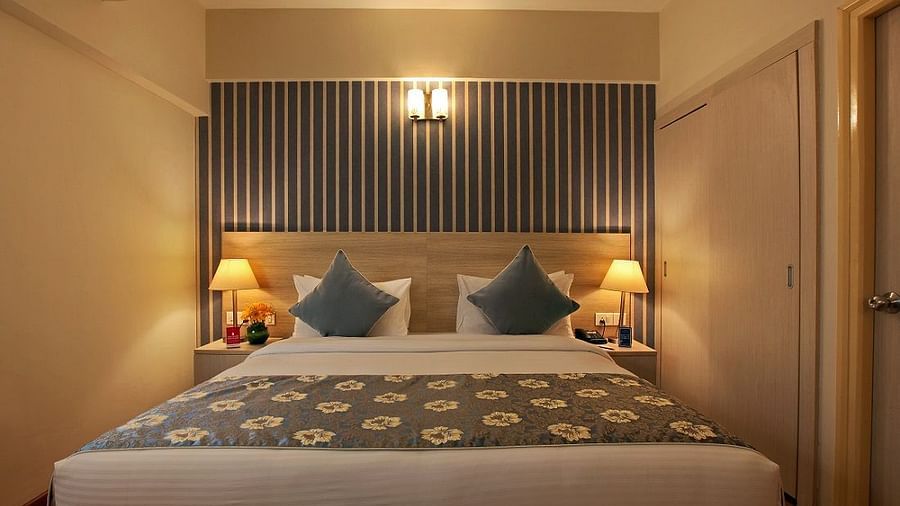 A double bed in the deluxe room at Starlit Suites, Bangalore
