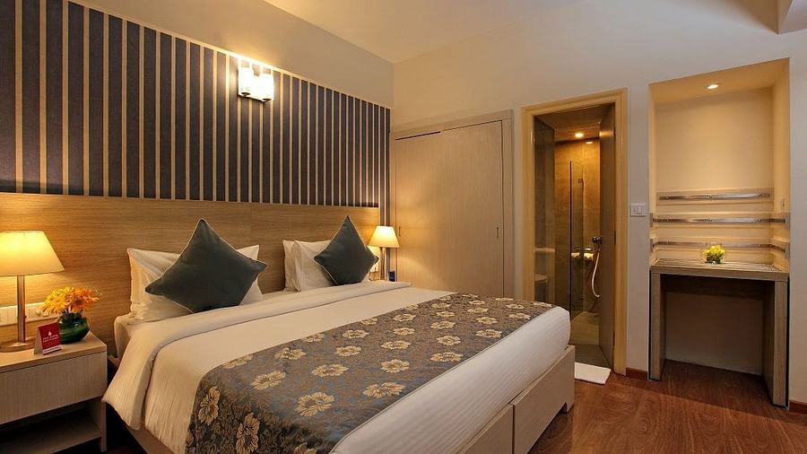 Deluxe room at Starlit Suites, Bangalore with a double bed