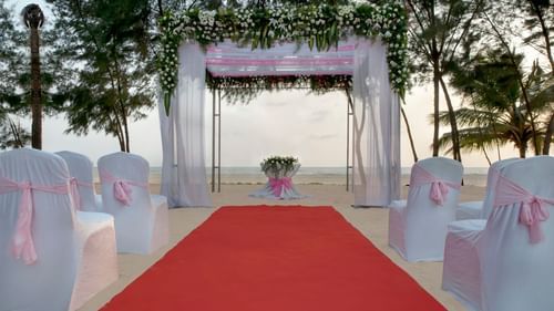 A glimpse of Sea Mist with a podium for exchanging vows and seating arrangement in front of it - Kenilworth Resort and Spa