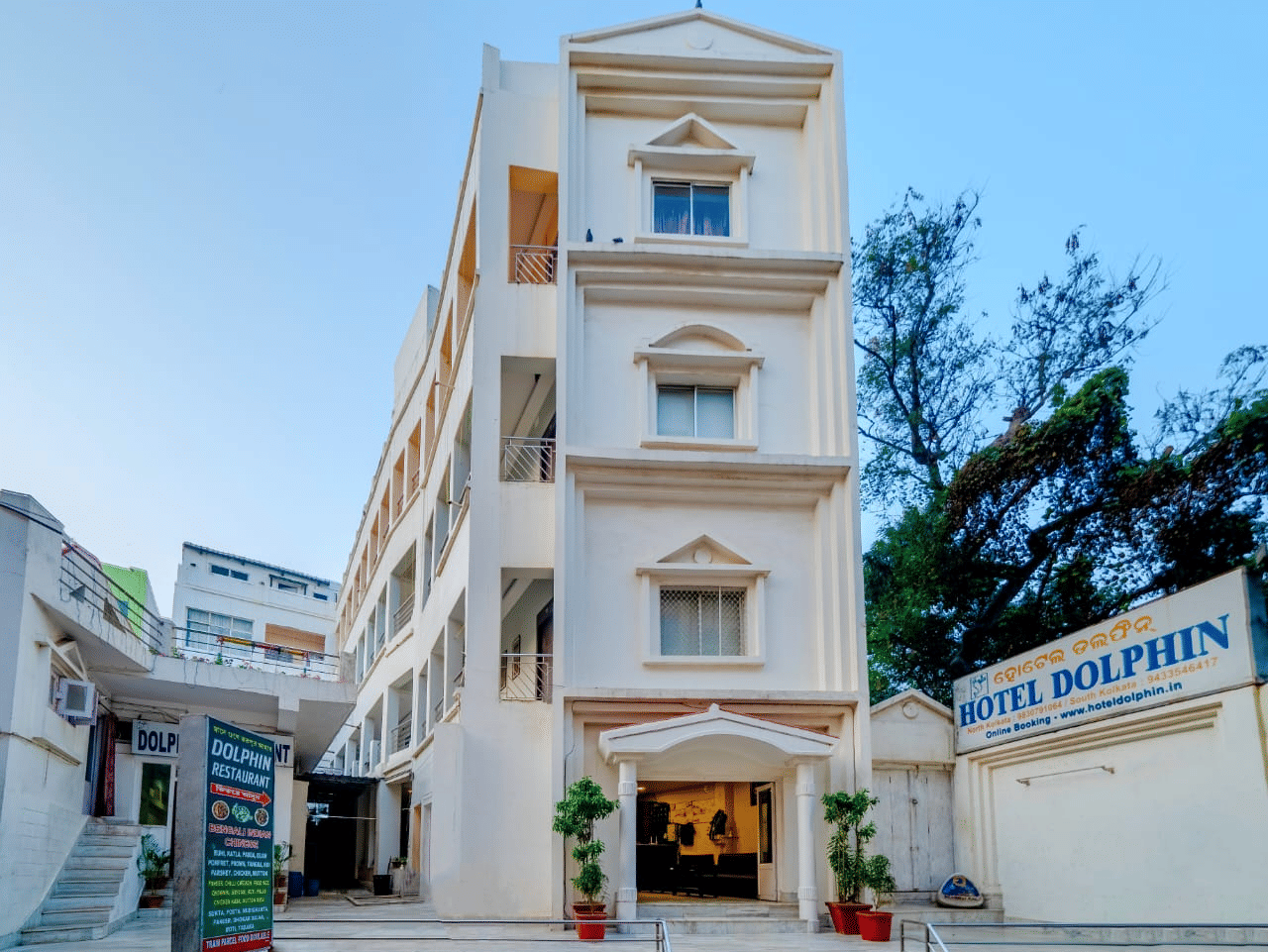 Front facade of Hotel Dolphin Puri with entrance signage and exterior architecture.