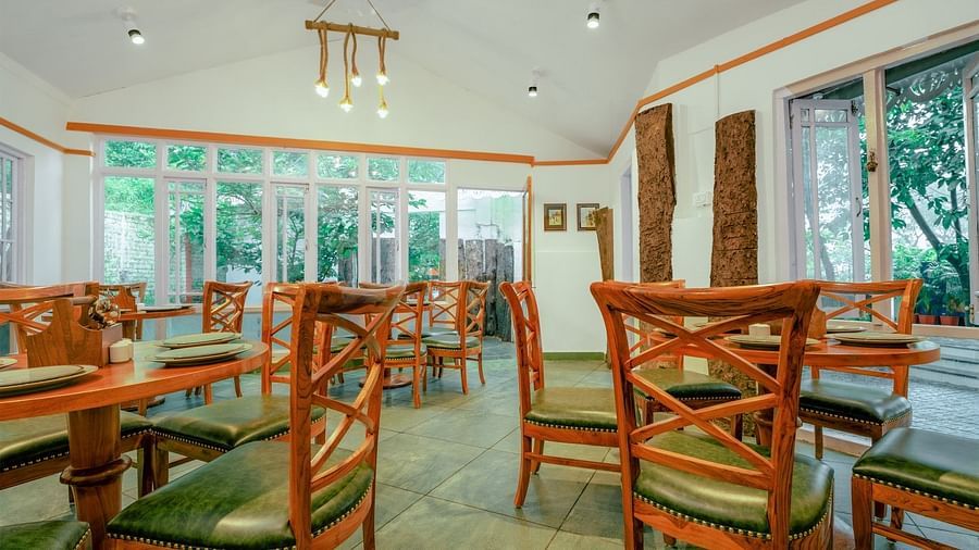  Wooden chairs and tables are neatly arranged in the dining area