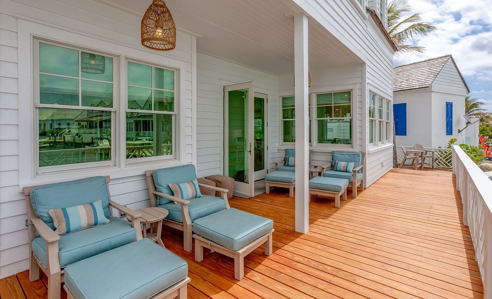 Outdoor wooden deck with seating and a view of the waterfront | Abaco Inn