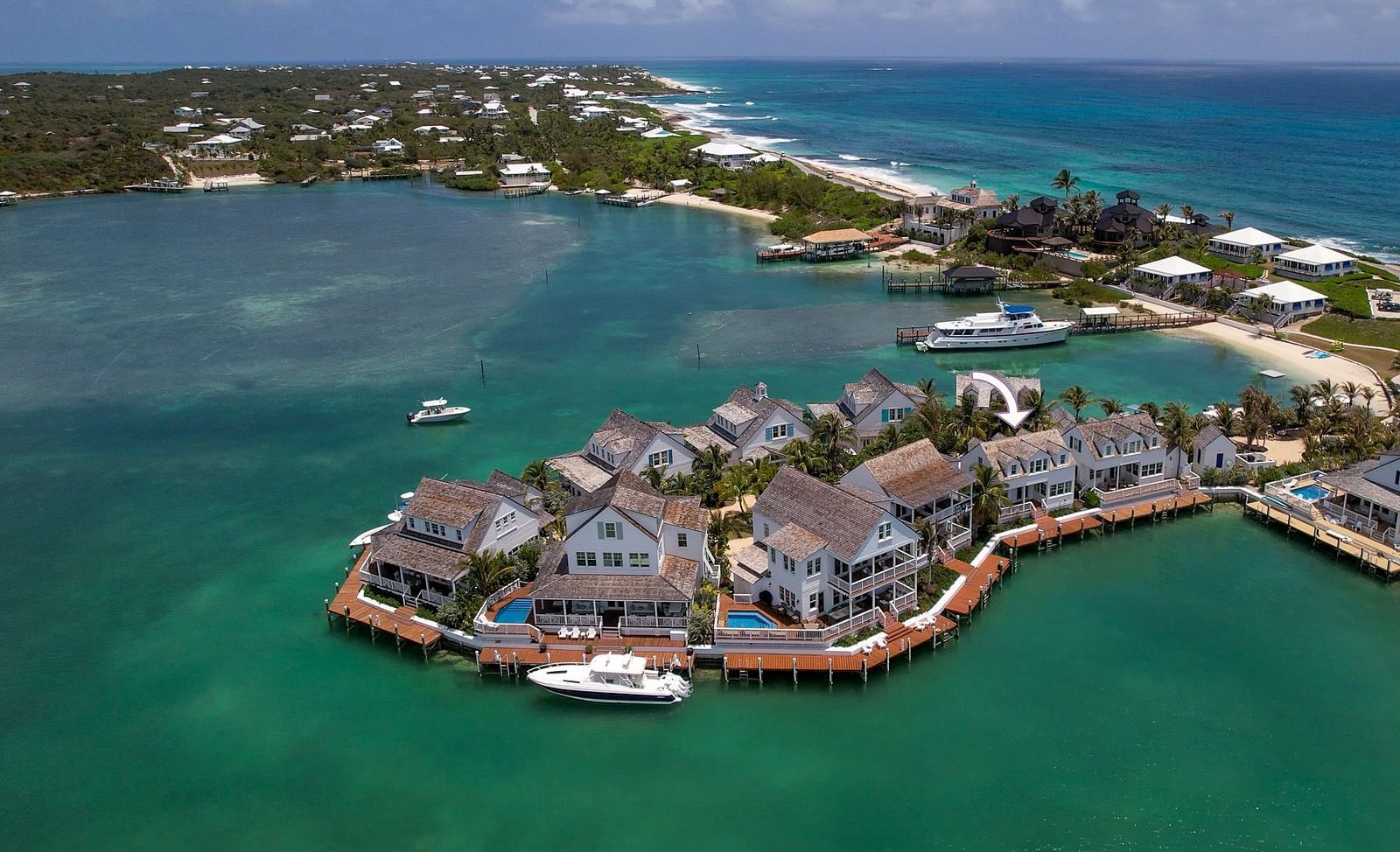 Aerial view of luxurious waterfront houses with private docs, boats docked nearby at Abaco Inn.