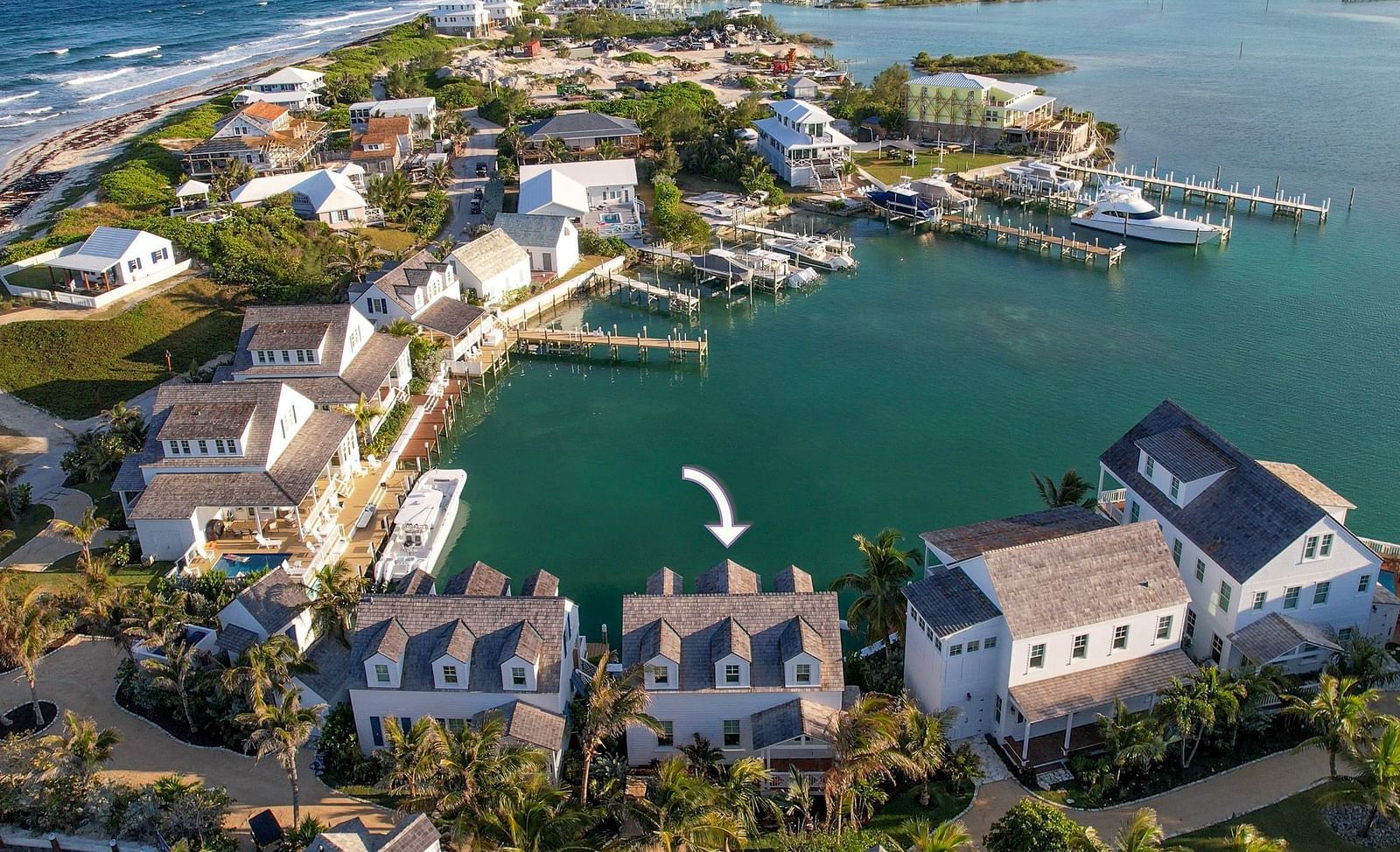Lot-9-Aerial view of luxurious waterfront houses with private docs, and a boat docked nearby at Abaco Inn.