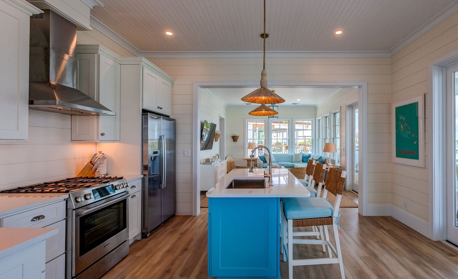 Modern kitchen with blue cabinetry, a large island, and appliances | Abaco Inn
