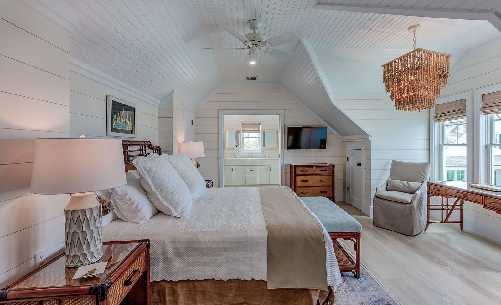 Spacious bedroom with a large bed, wicker furniture, and natural light | Abaco Inn