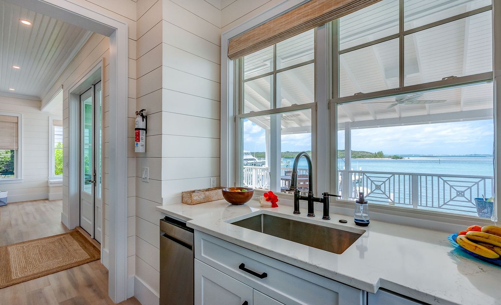 Kitchen with a water view, white cabinetry, and modern appliances | Abaco Inn