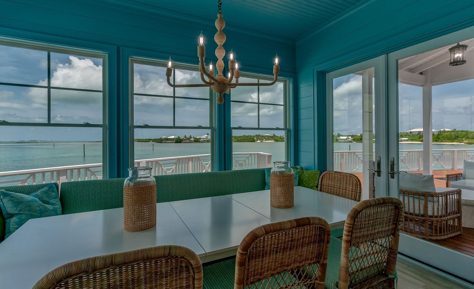Dining room with a coastal chandelier and floor-to-ceiling windows | Abaco Inn