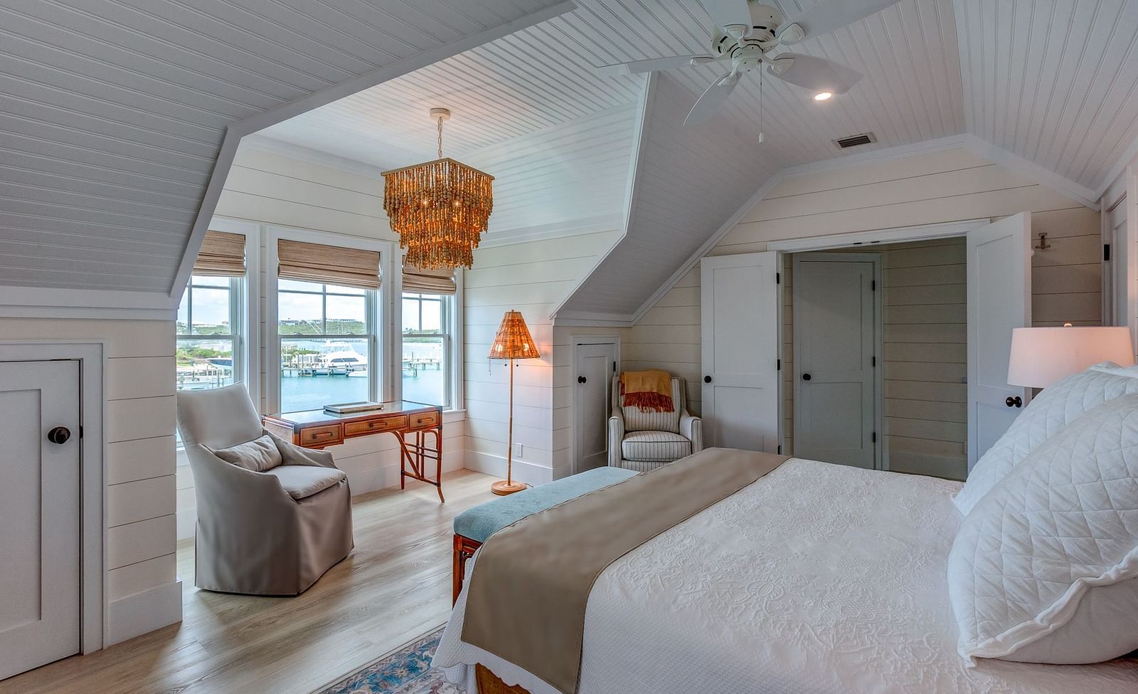 Bedroom with a king size bed, armchair, and sloped ceiling | Abaco Inn