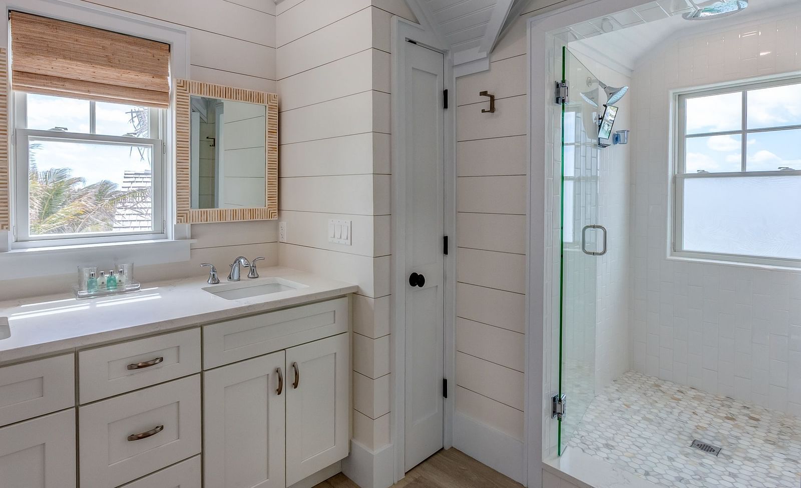 Bathroom with a window, vanity, and a built-in bathtub | Abaco Inn