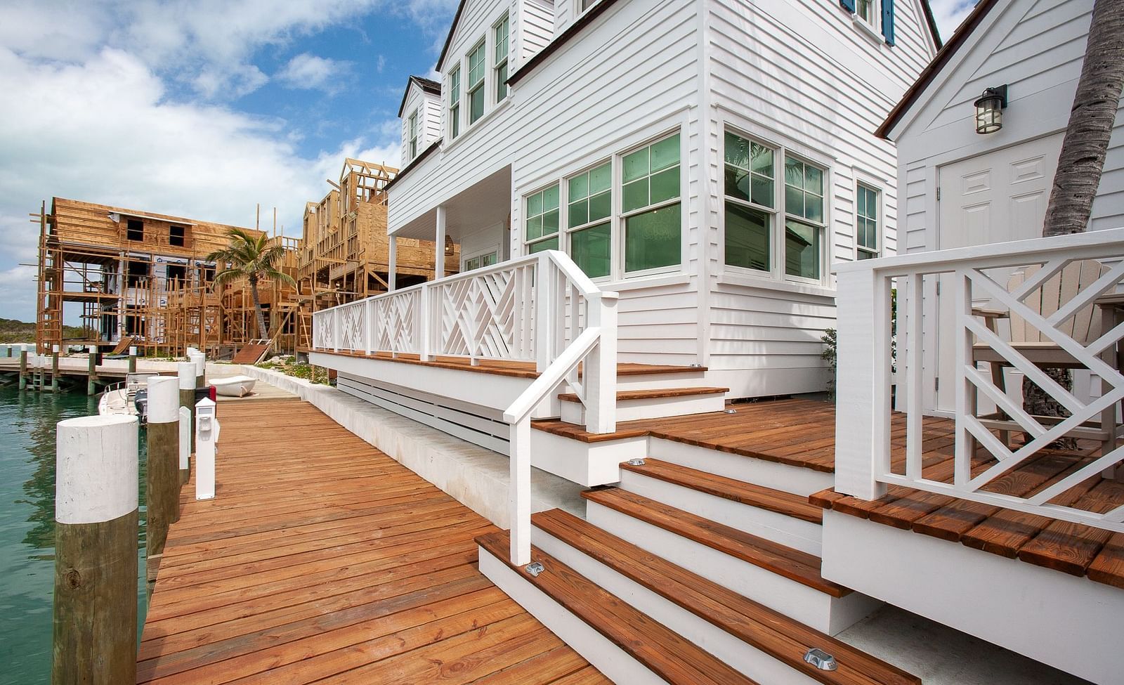 Wooden deck with steps leading to a white coastal-style building | Abaco Inn