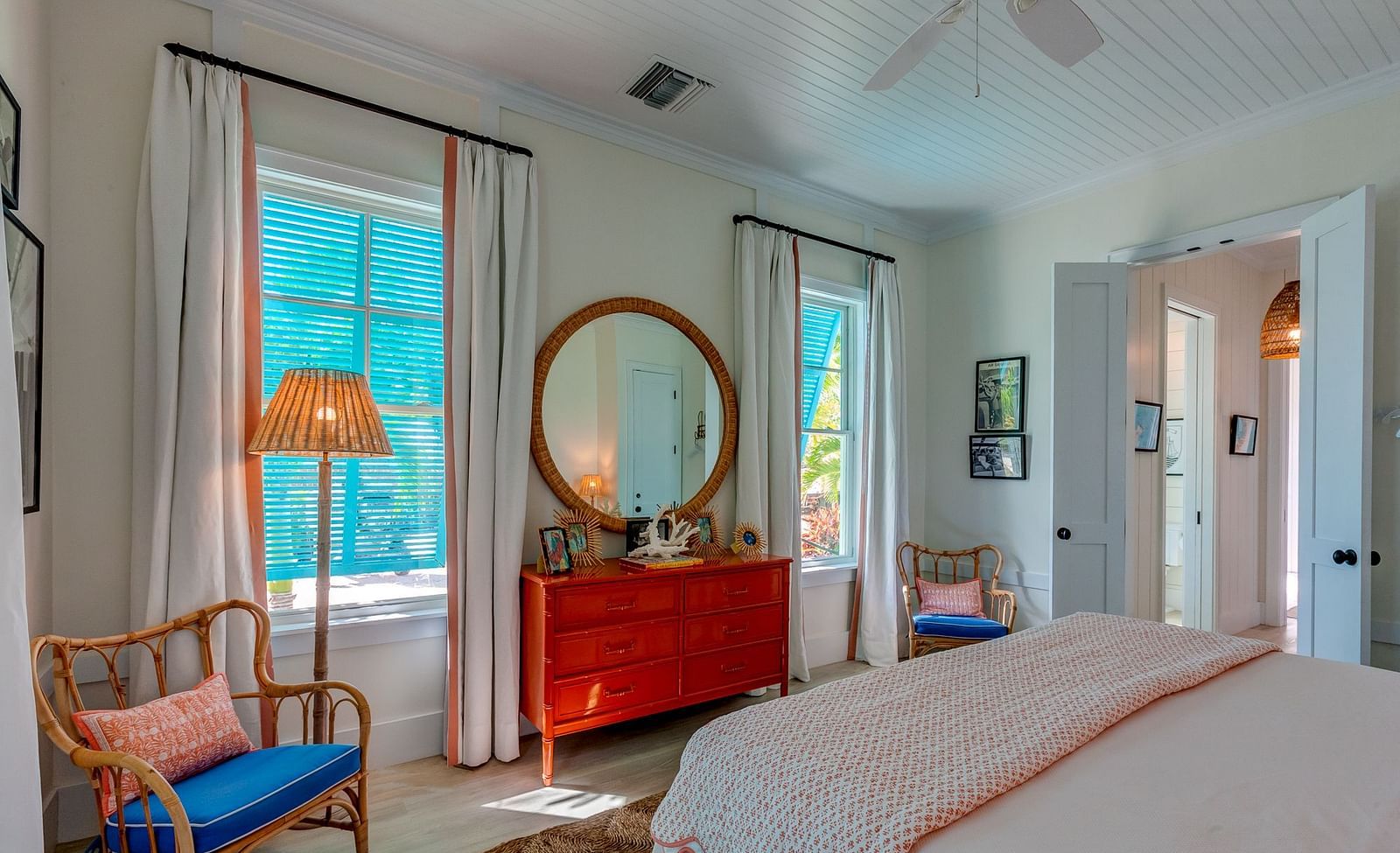 Bright bedroom with a large bed, wicker chair, and windows with natural light | Abaco Inn
