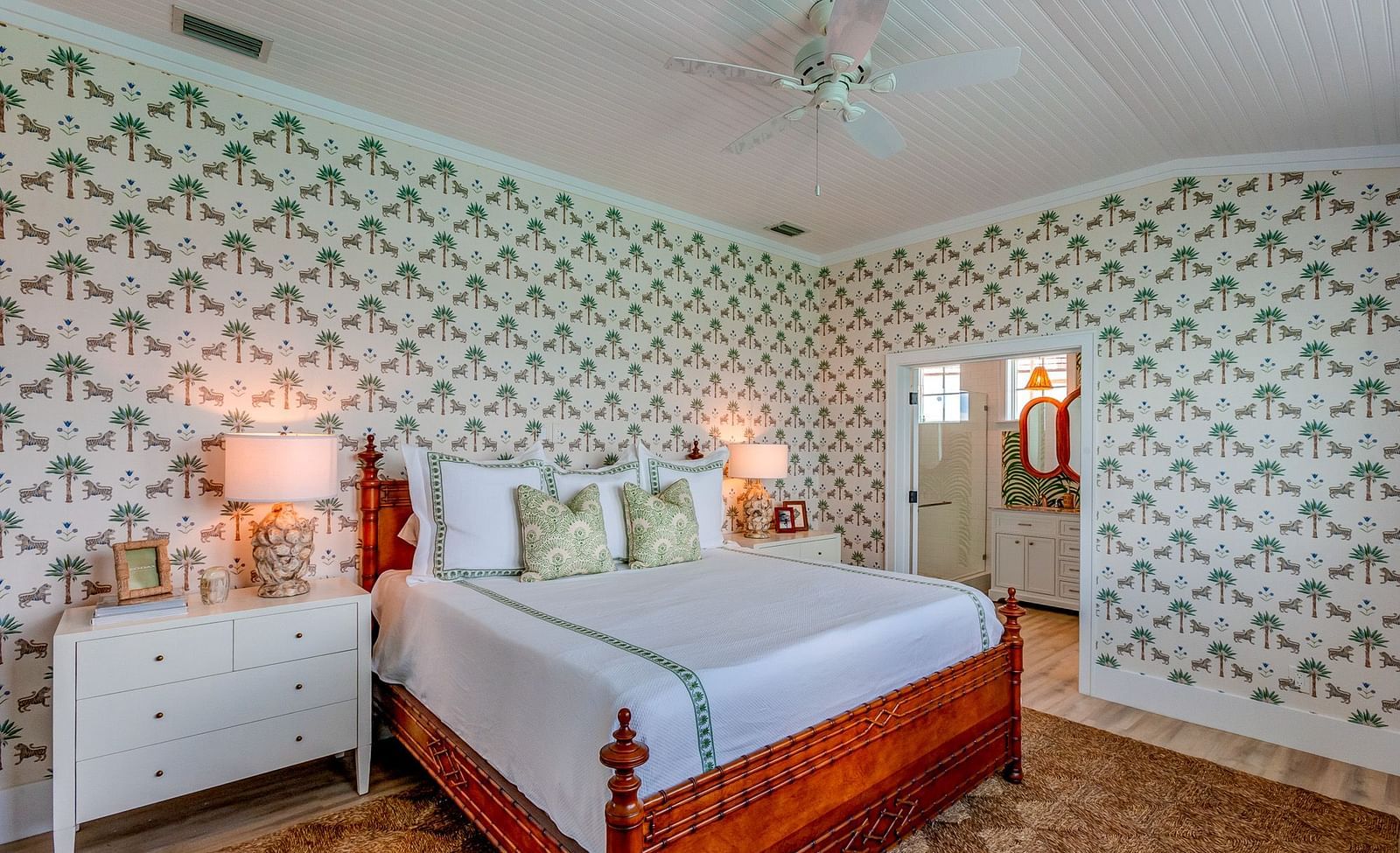 Bedroom with a bed, patterned wallpaper, and soft lighting | Abaco Inn