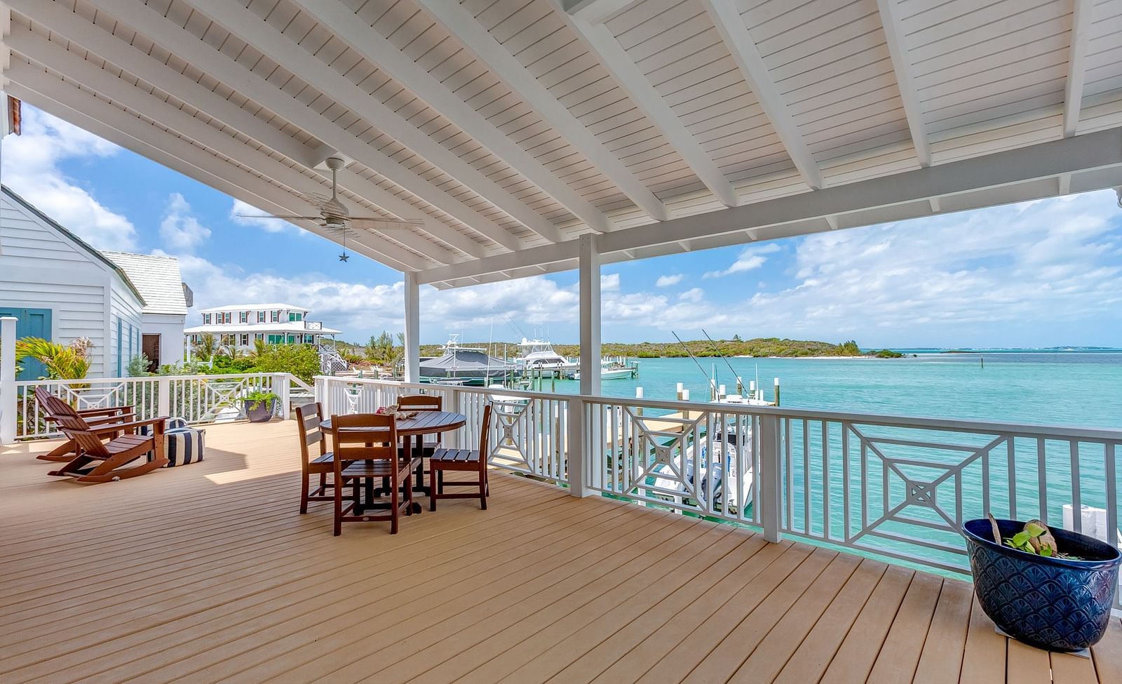 Outdoor deck with seating overlooking turquoise waters | Abaco Inn