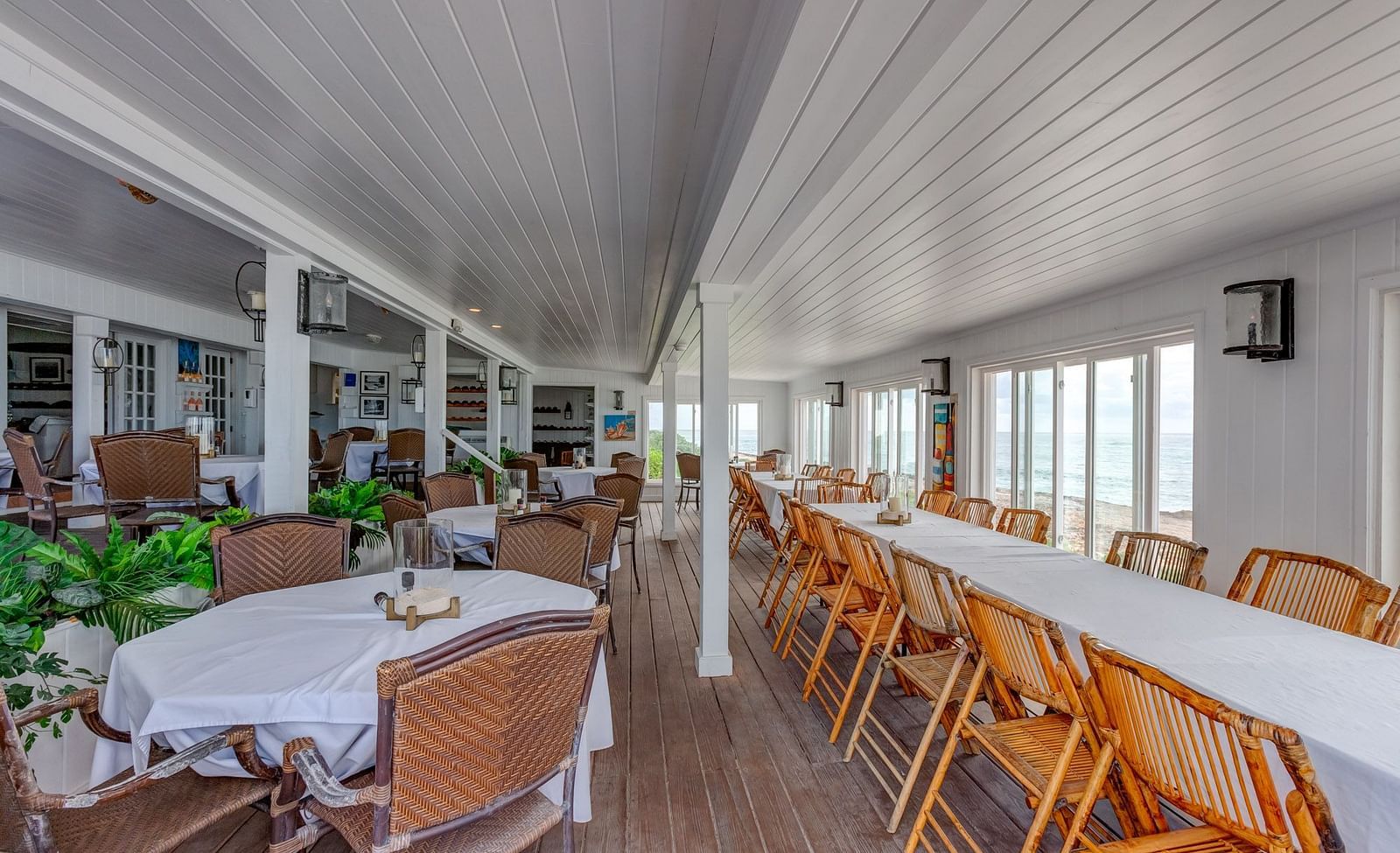 Indoor restaurant with white ceiling and wooden furniture | Abaco Inn