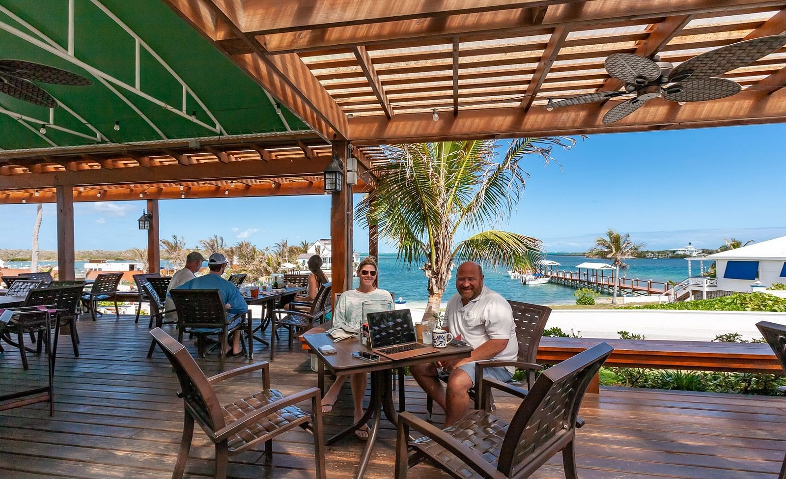 Outdoor dining area with ocean view and wooden roof | Abaco Inn