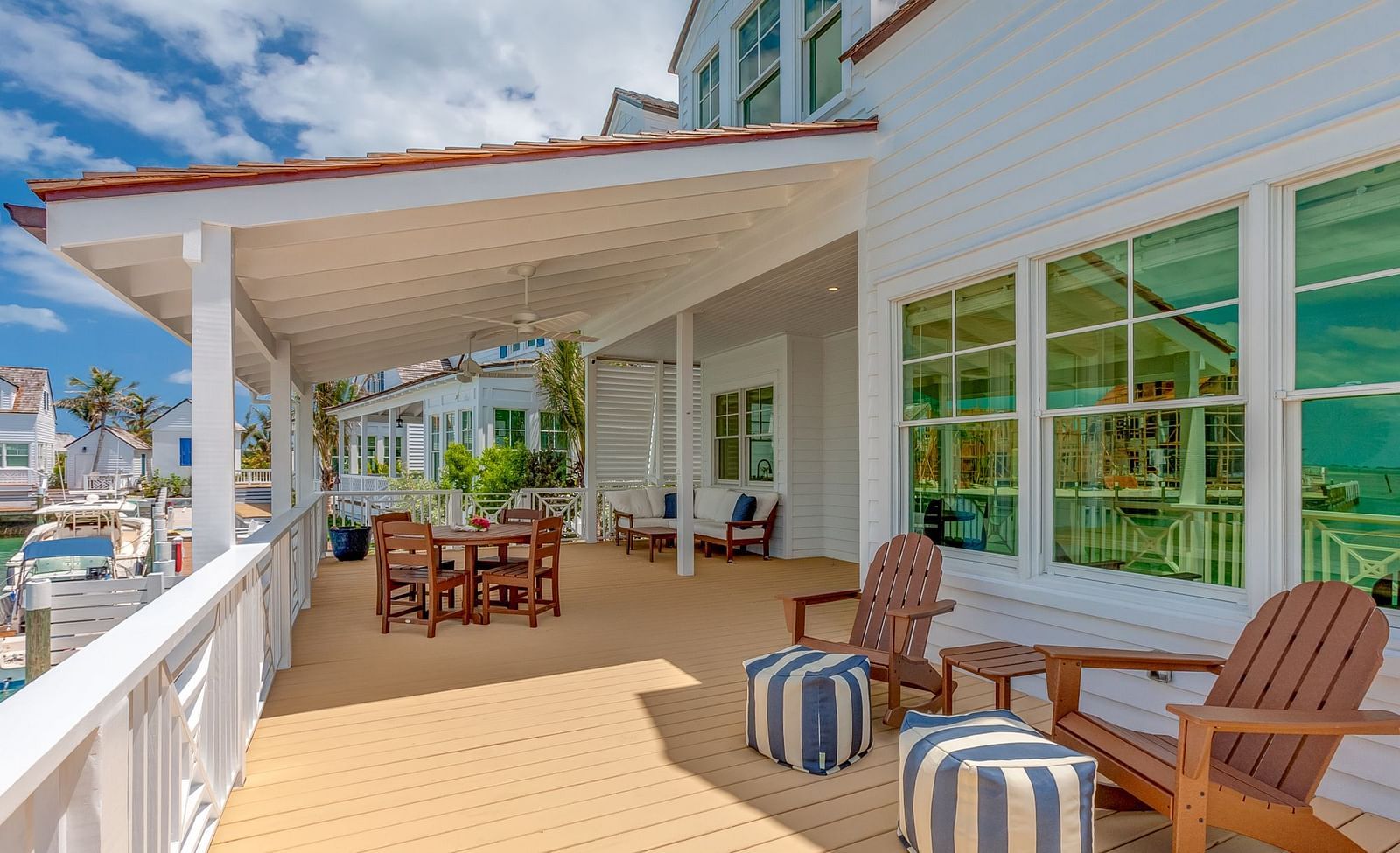 Outdoor seating area on a covered patio with wooden flooring | Abaco Inn