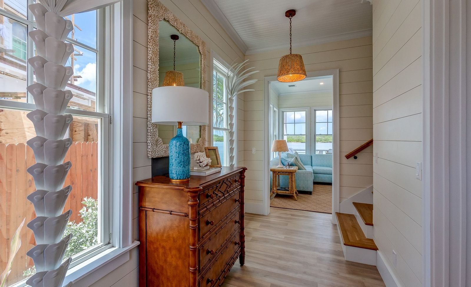 Hallway with coastal decor, wooden furniture, and large windows | Abaco Inn
