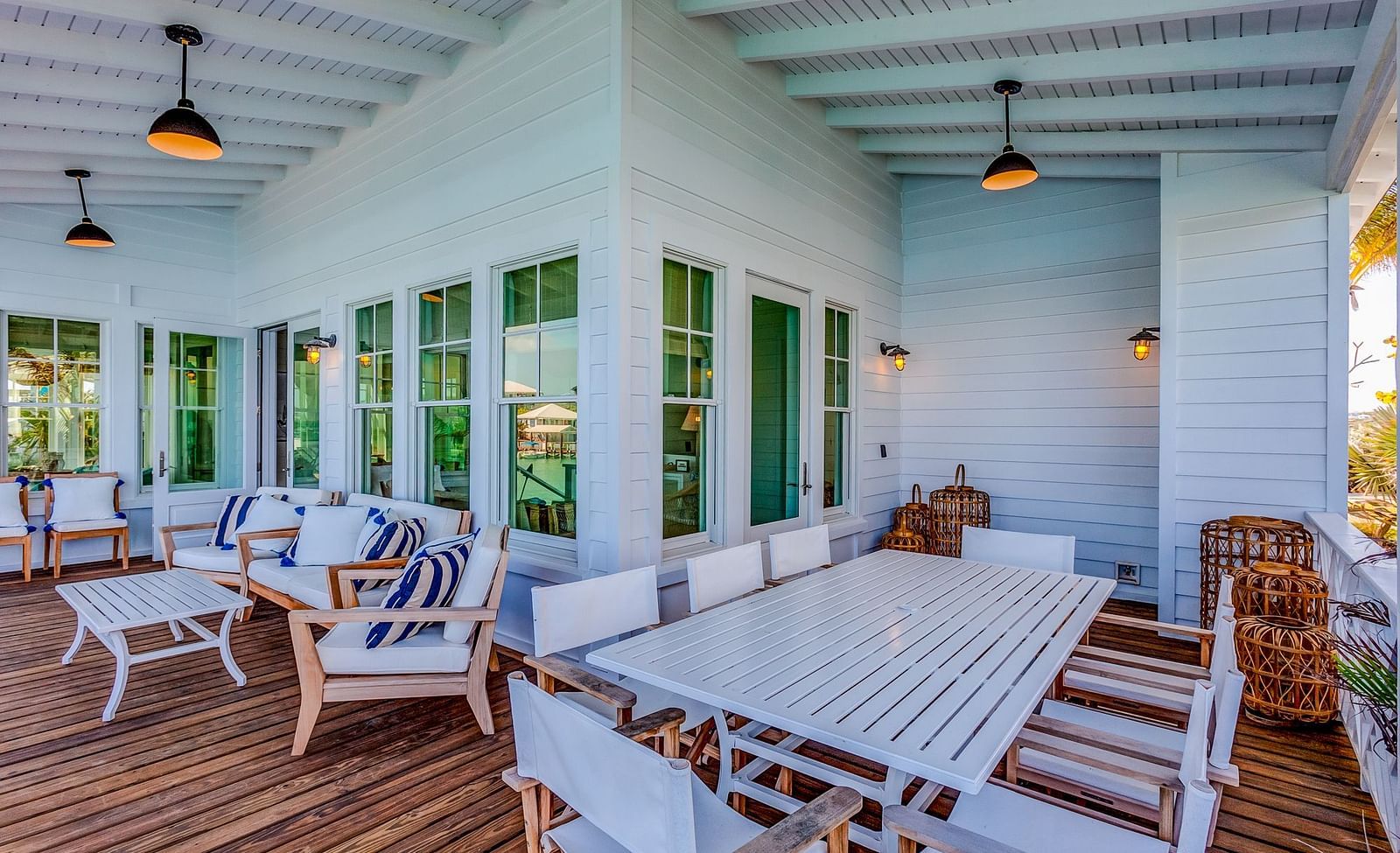 Open-air dining area with a long white table and cushioned seating | Abaco Inn