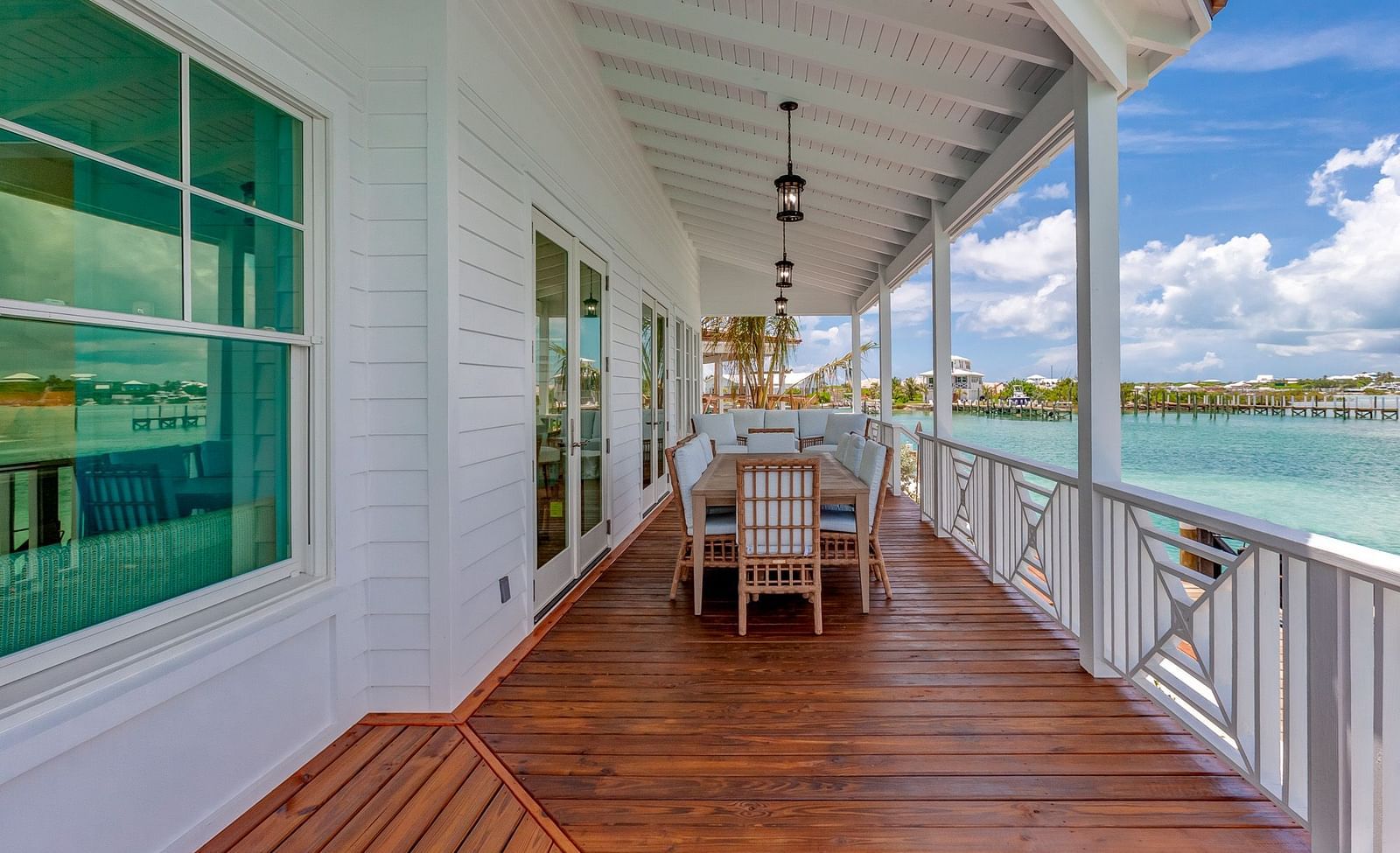 Outdoor dining area on a wooden deck with ocean views | Abaco Inn