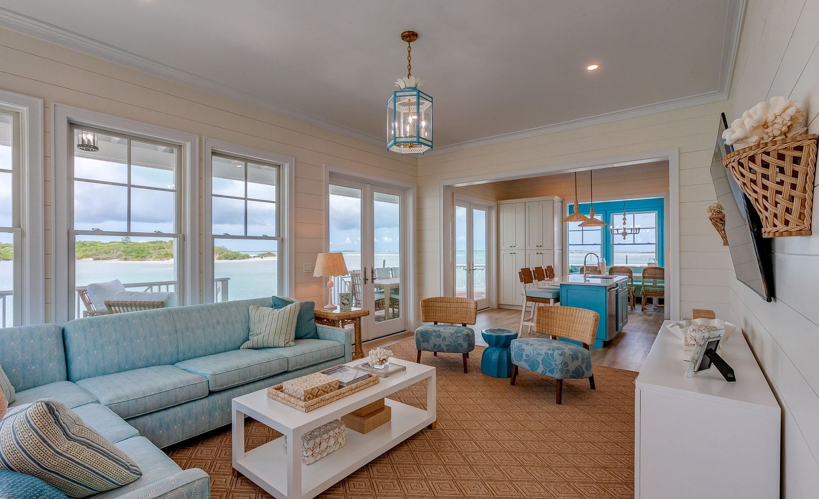 Living area with pastel blue seating, large windows, and décor | Abaco Inn