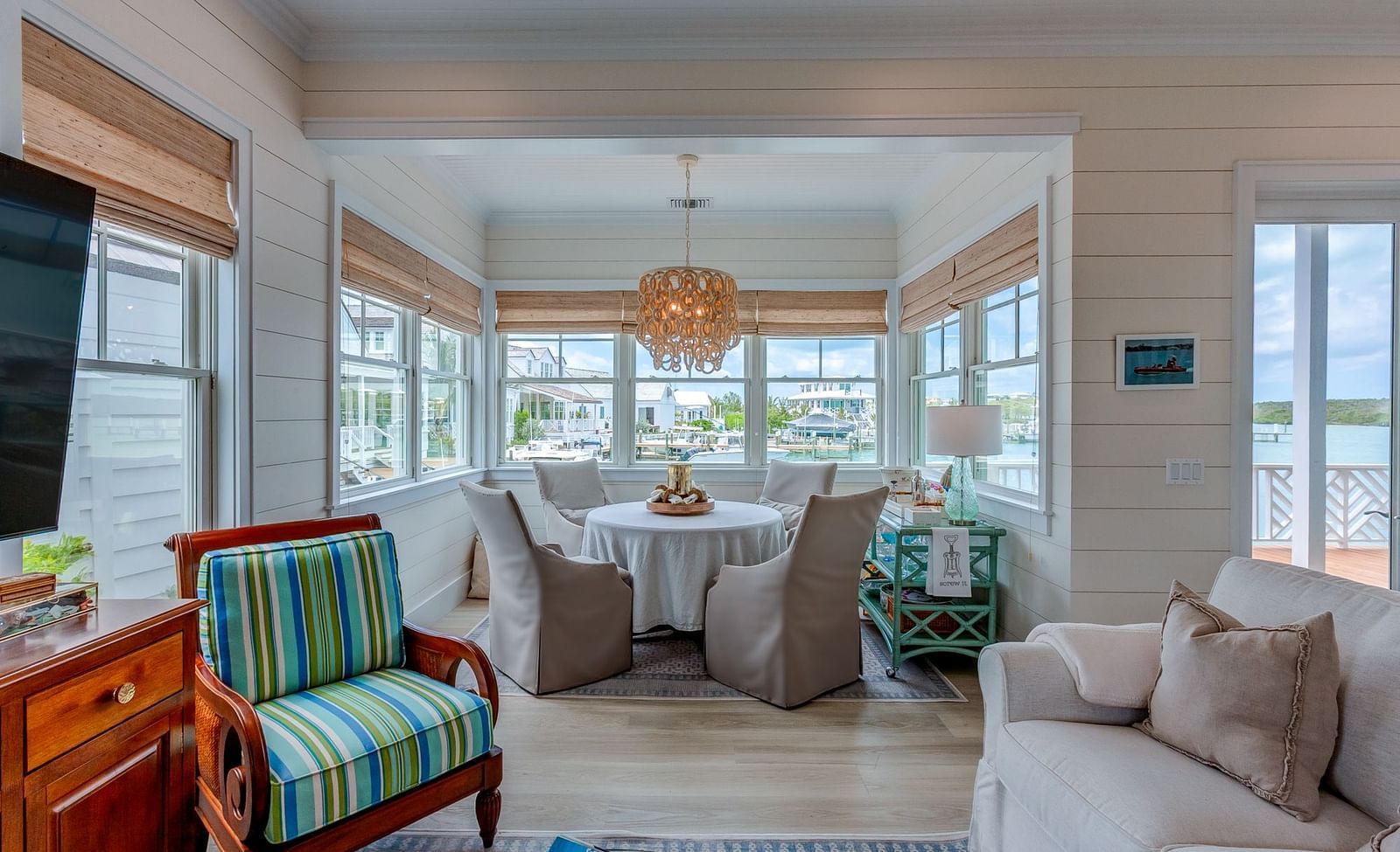 Living room with a large sectional sofa, armchairs, and waterfront views | Abaco Inn