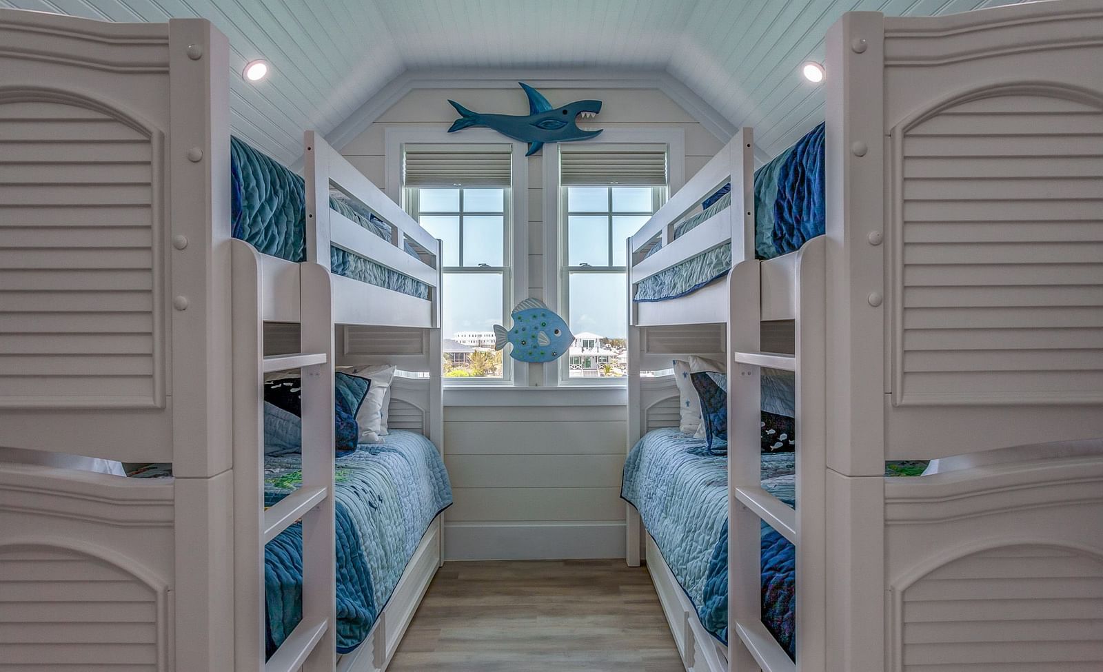 a room with two bunk beds and windows with a sea view at Abaco Inn.