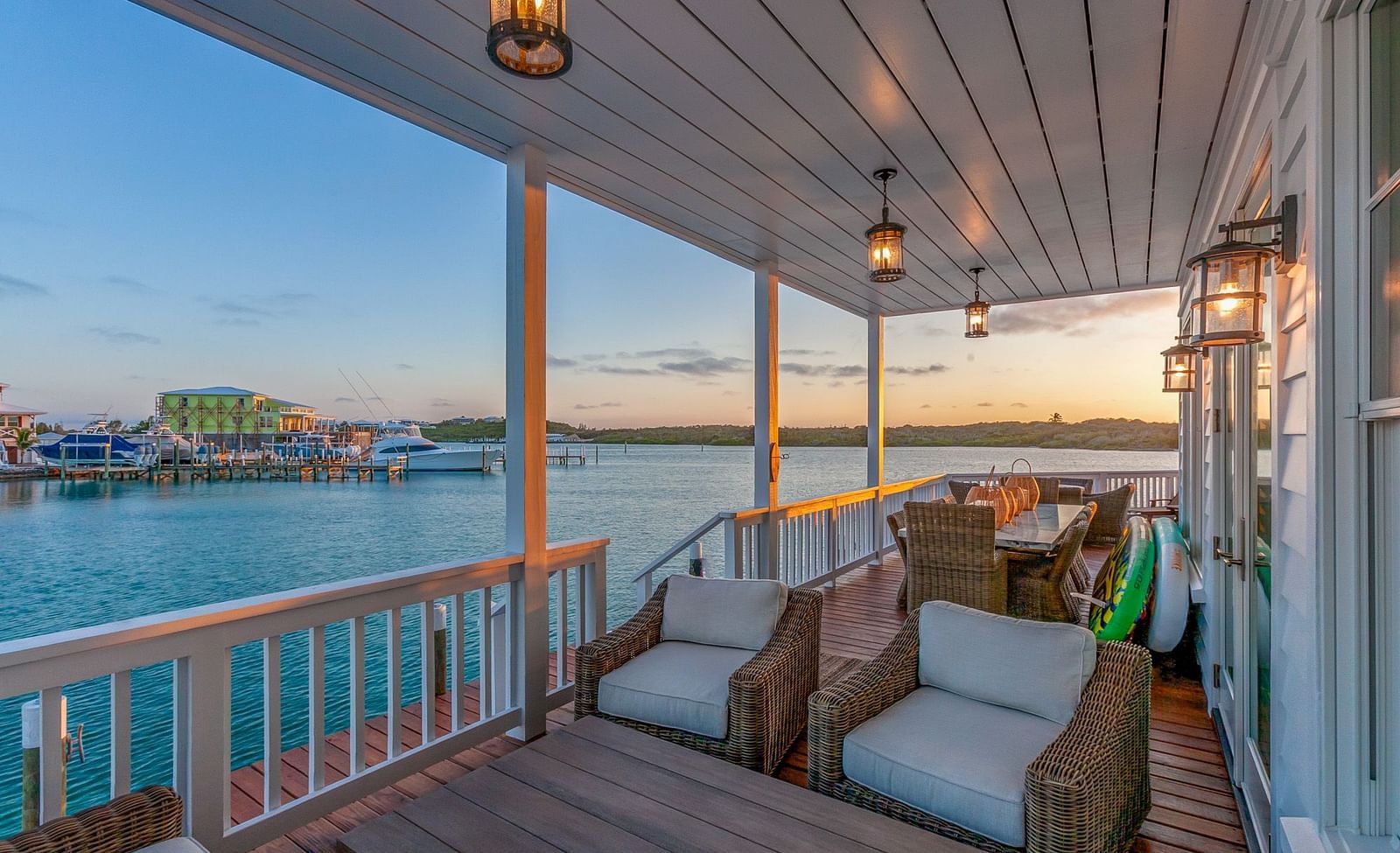Sitting area on the dock with comfortable chairs and a table with the sea view at Abaco Inn.