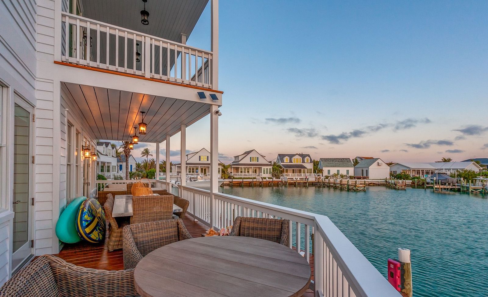 Outdoor sitting area on the dock with wooden tables and chairs and a view of the sea at Abaco Inn.