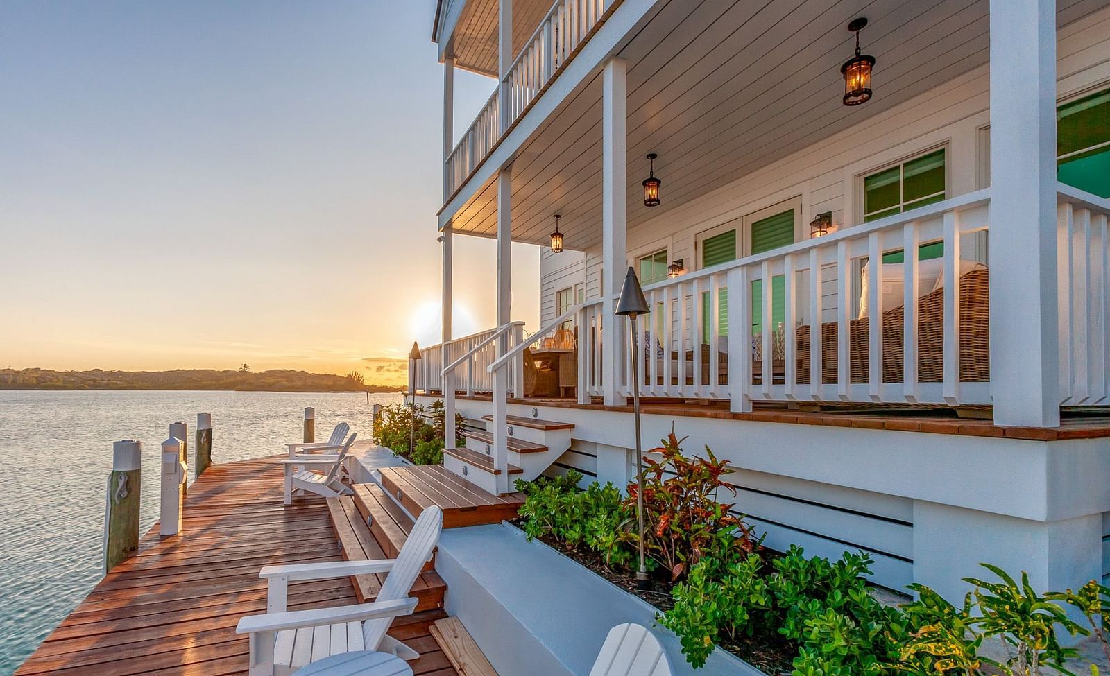facade of  Abaco Inn with chairs on the dock and a view of the sea.