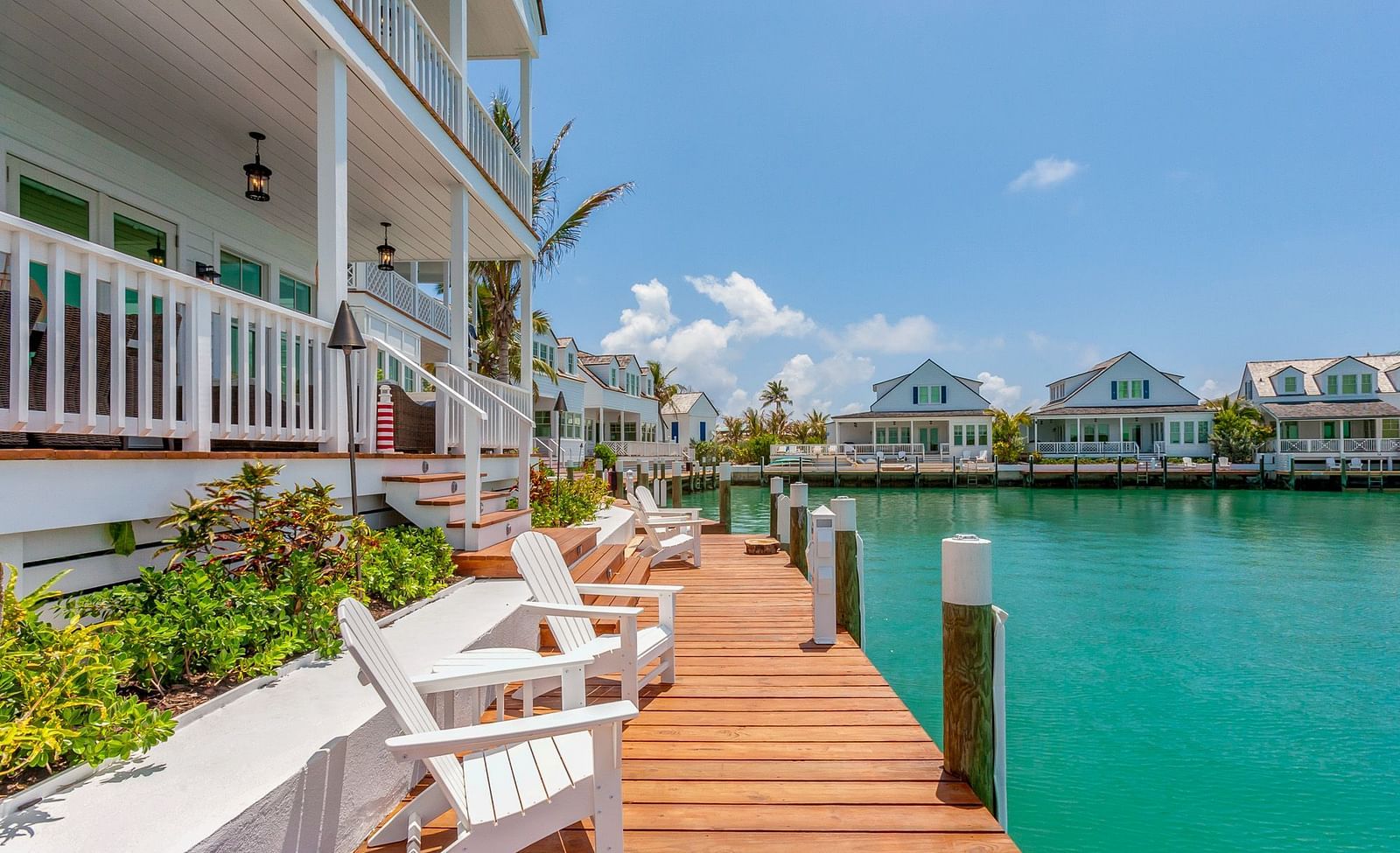 facade of  Abaco Inn with chairs on the dock and a view of the sea.