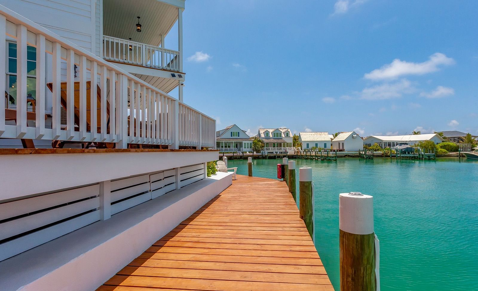 side view of Abaco Inn on a dock with a sea view.