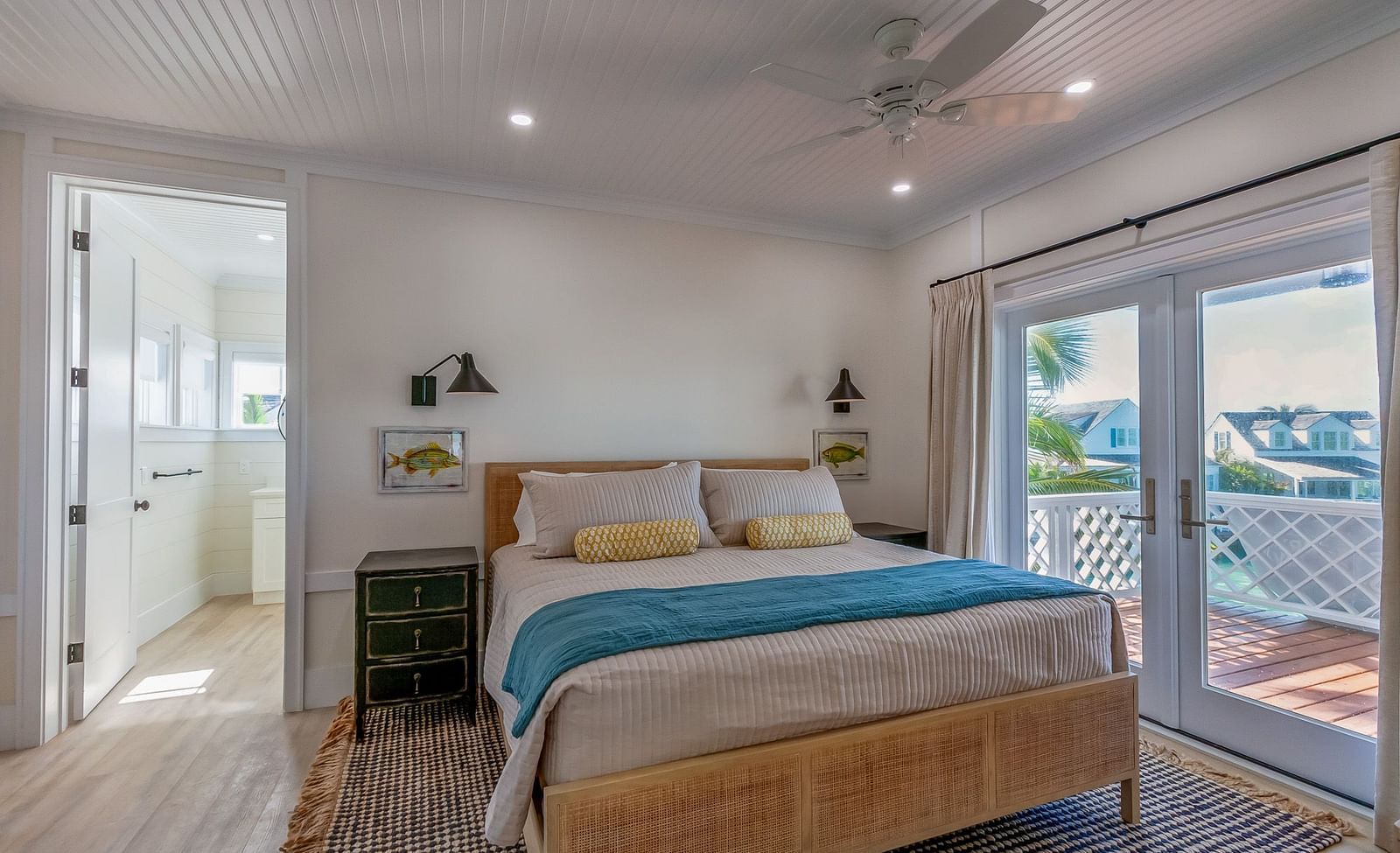 a bedroom with a double bed, a bedside drawer,  a door leading to the attached bathroom and a glass door leading to the balcony with a sea view at Abaco Inn.
