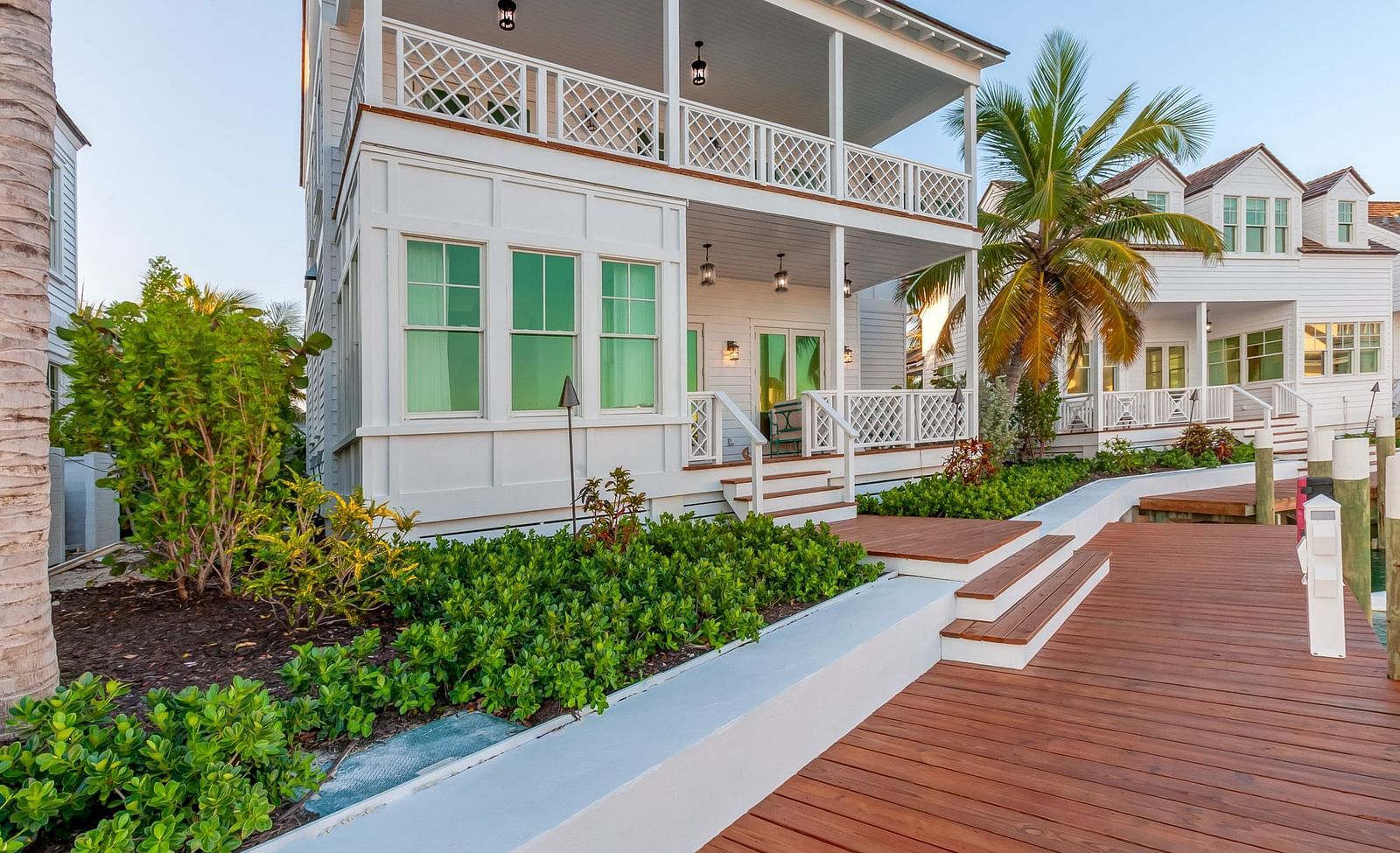 Facade of Abaco Inn with wooden dock and greenery.