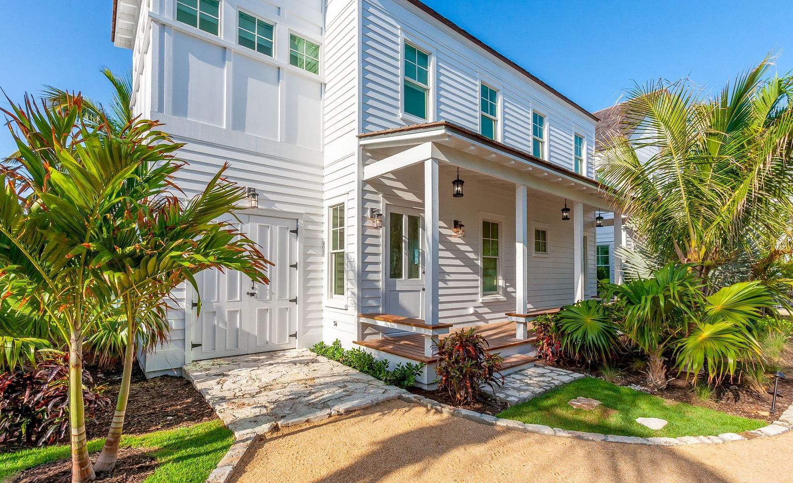 Facade of Abaco Inn with palm trees and a path leading towards it.