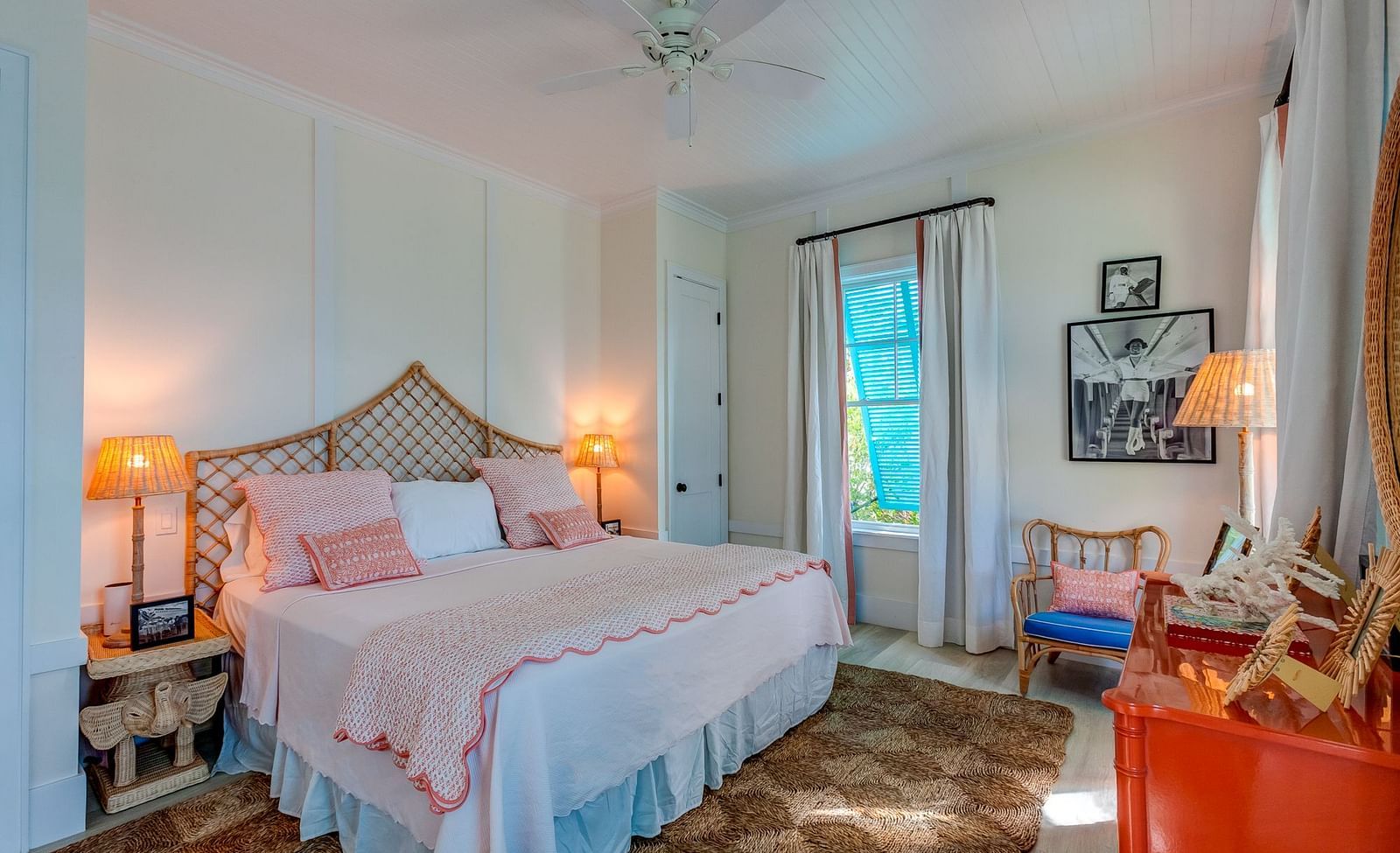 Bedroom with a pink bedspread, wooden accents, and soft lighting | Abaco Inn