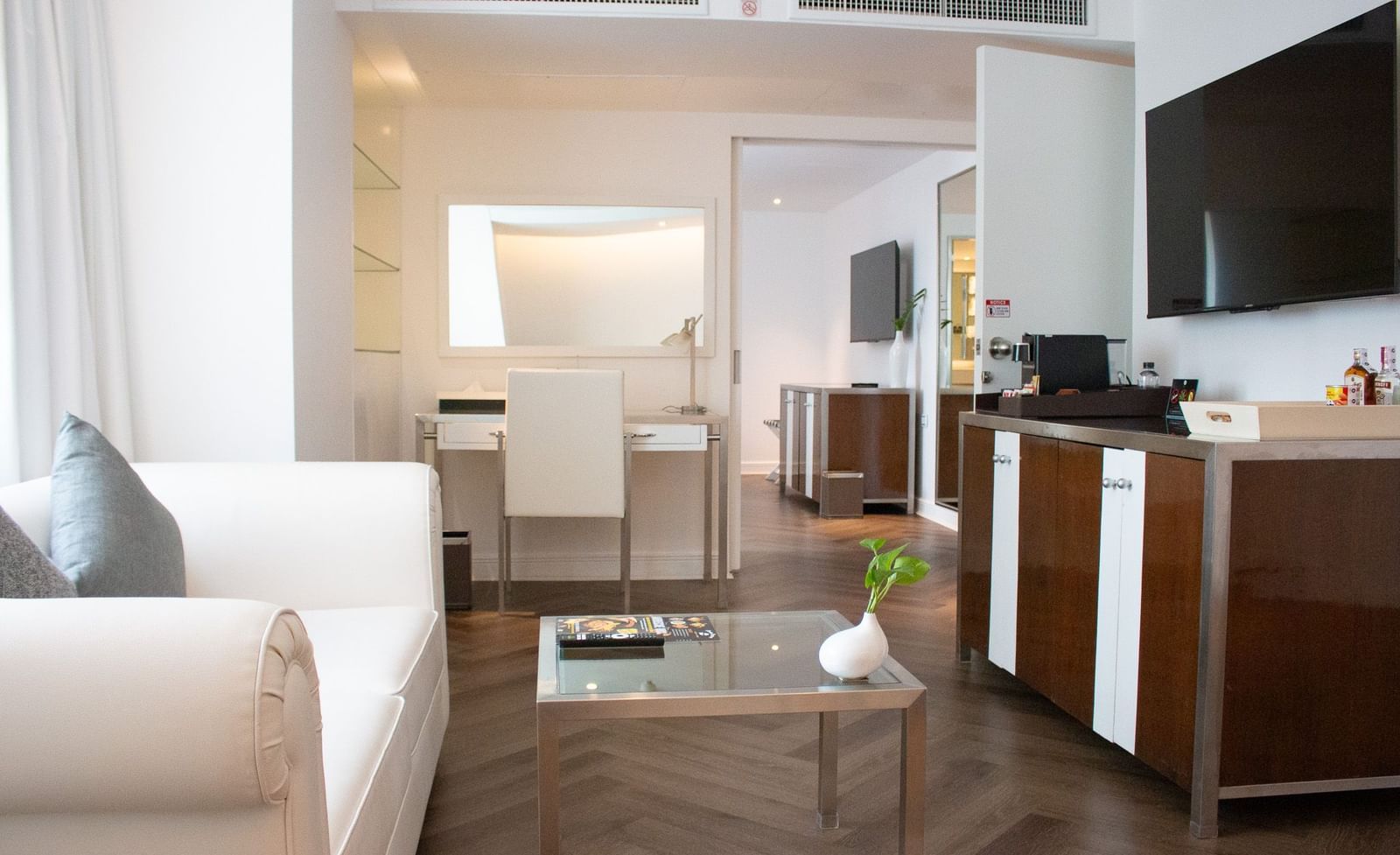 Spacious guest room at Night Hotel Bangkok with seating area and modern furnishings.