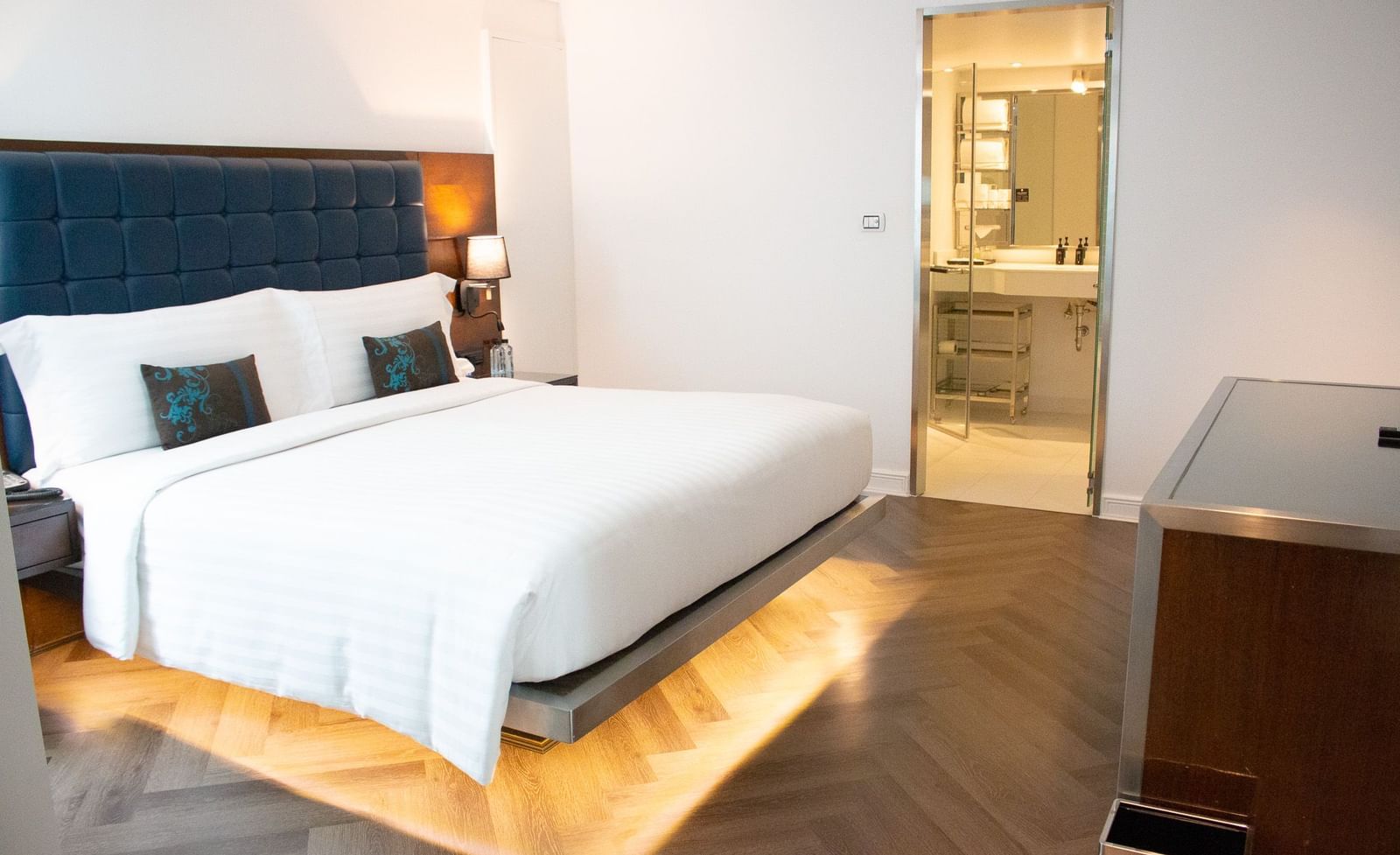 Bedroom at Night Hotel Bangkok with king bed and warm ambient lighting.