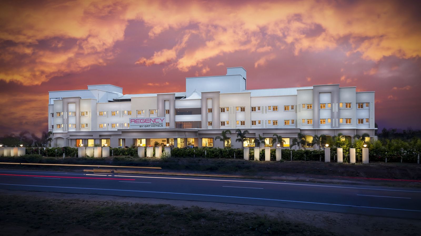 Facade image of Regency Tiruttani by GRT Hotels at dusk.