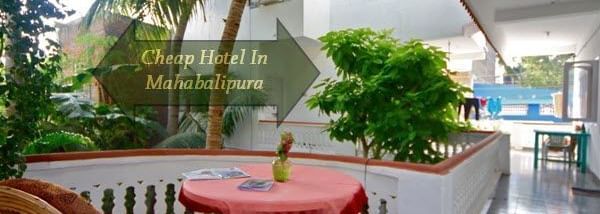 An outdoor patio with multiple chairs, a table, and plants beside palm trees, with 'Cheap Hotels in Mahabalipura' written on it.