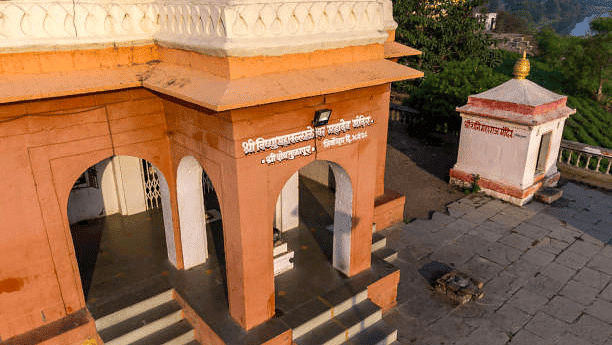 Entrance to a temple complex with traditional architecture and visitor access.