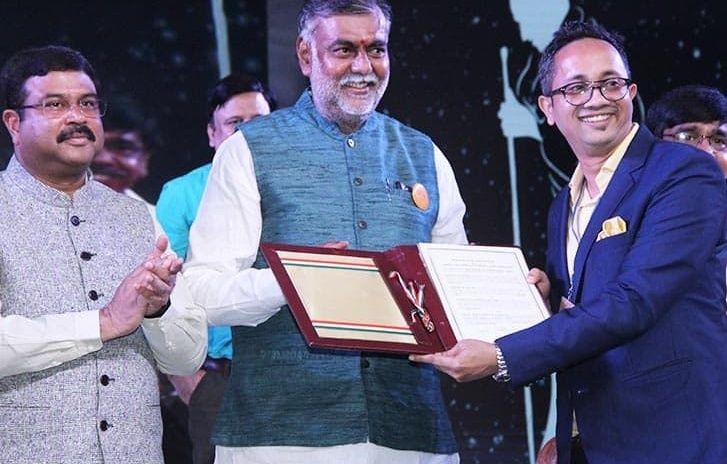 Prahlad Singh Patel presents an award at an event.