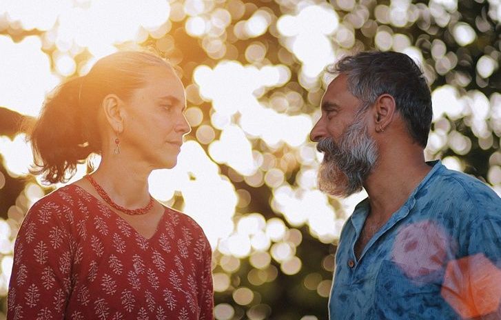 Man and woman looking at each other in the sun.