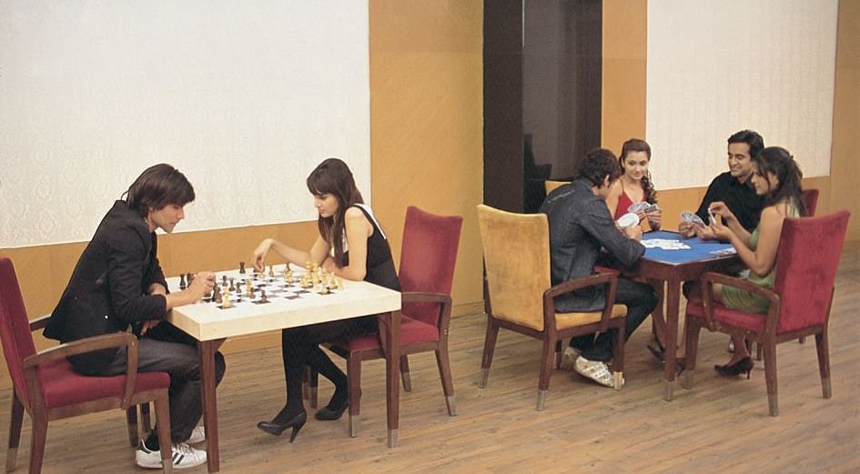A dining seating arrangement with people having food at Nirvana Luxury Hotel, Ludhiana.