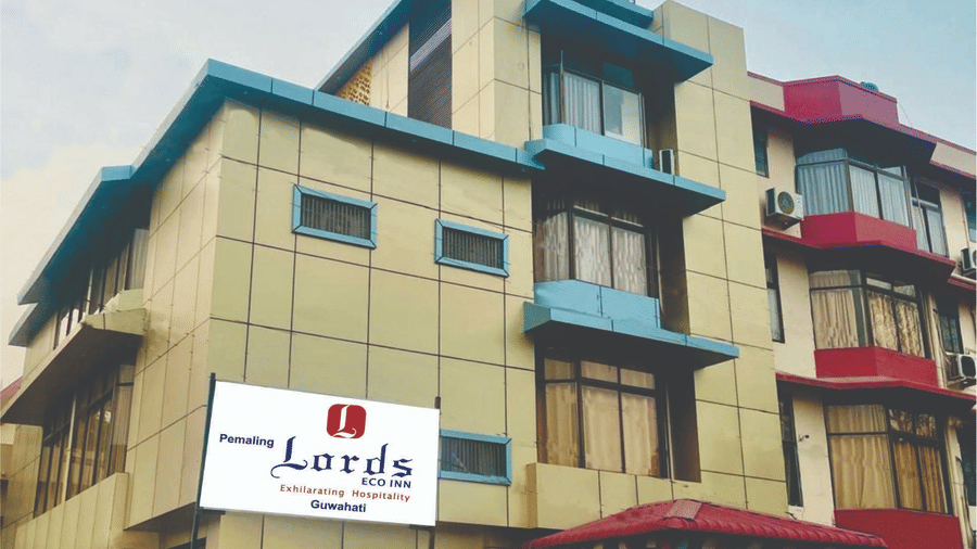 The exterior facade of Pemaling Lords Eco Inn Guwahati featuring the property signage and modern architectural design.