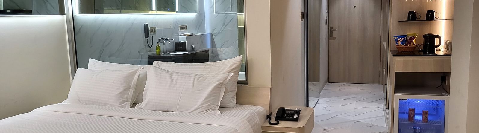 Image of a double bed in the Double 6ix Sea View with Jacuzzi Double Sized Bed at 6ix Seashore Hotel, Port Blair