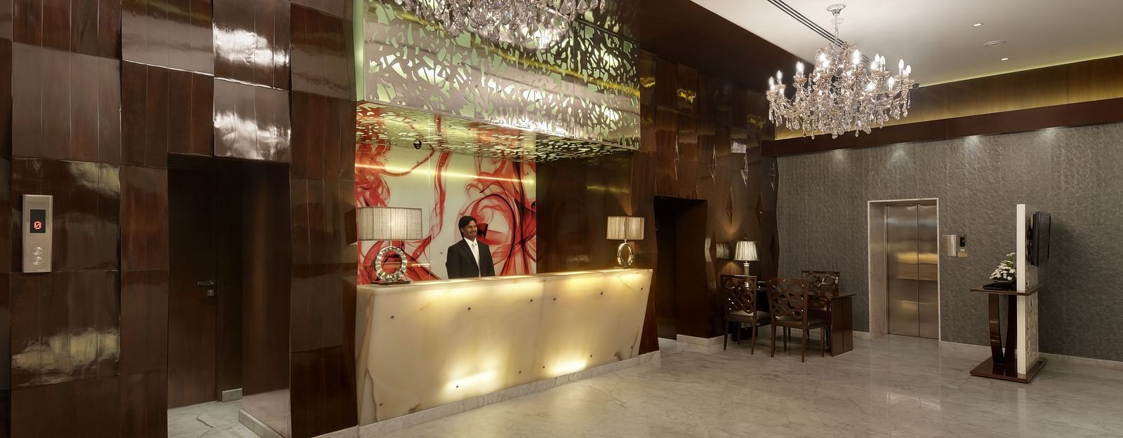 Elegant hotel lobby with marble flooring and chandelier lighting at The Elanza  Hotel.
