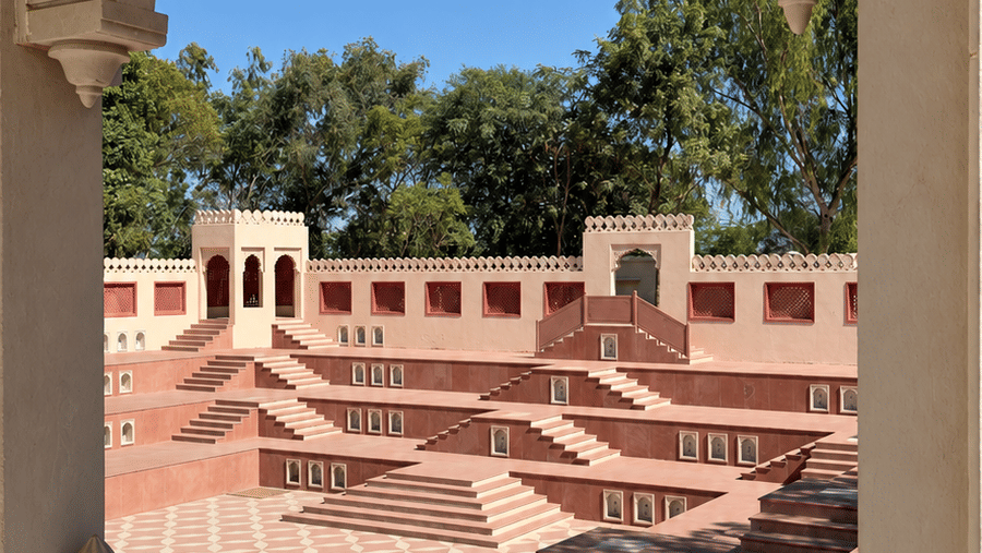 Baori-Stepwell-Events Venue-Day View-Stepped pink courtyard through ornate arch