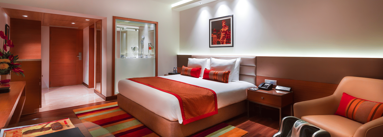 Grand Club Room with king size bed and sofa chair at Grand Chennai By GRT Hotels.