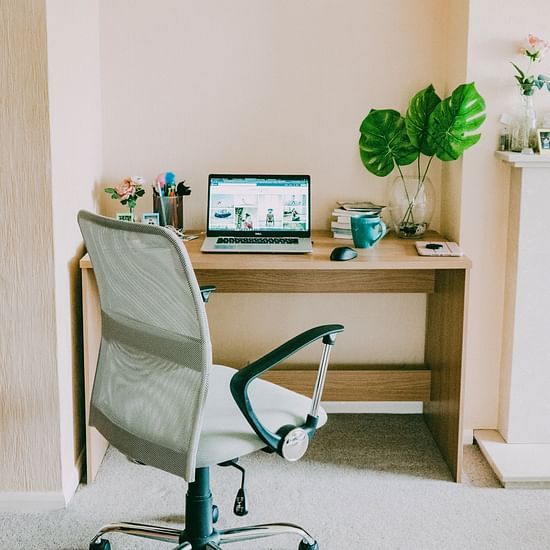 chair and table with a laptop and mouse